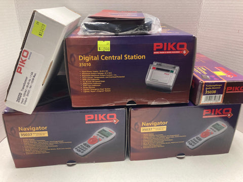 Piko Wireless DCC System Includes: Digital Central Station (35010), Radio Receiver (35038), 2 Navigators (35037), 3 Switch Machines w/ DCC (35016)